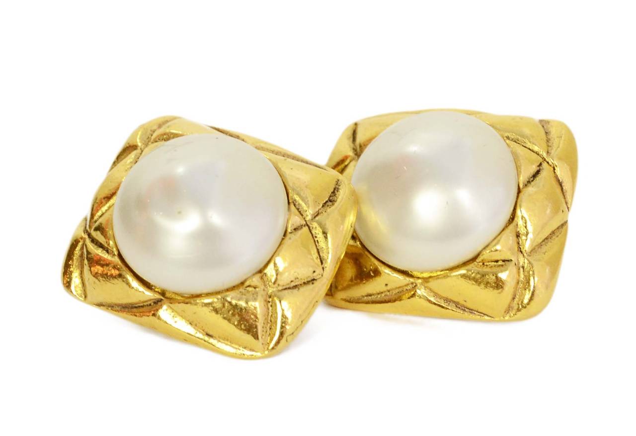 Chanel Vintage '70s-'80s Quilted Gold Square & Pearl Clip On Earrings
Made in: France
Year of Production: 1970s-1980s
Stamp: Chanel CC Made in France
Closure: Clip on
Color: Goldtone and ivory
Materials: Metal and faux pearl
Overall