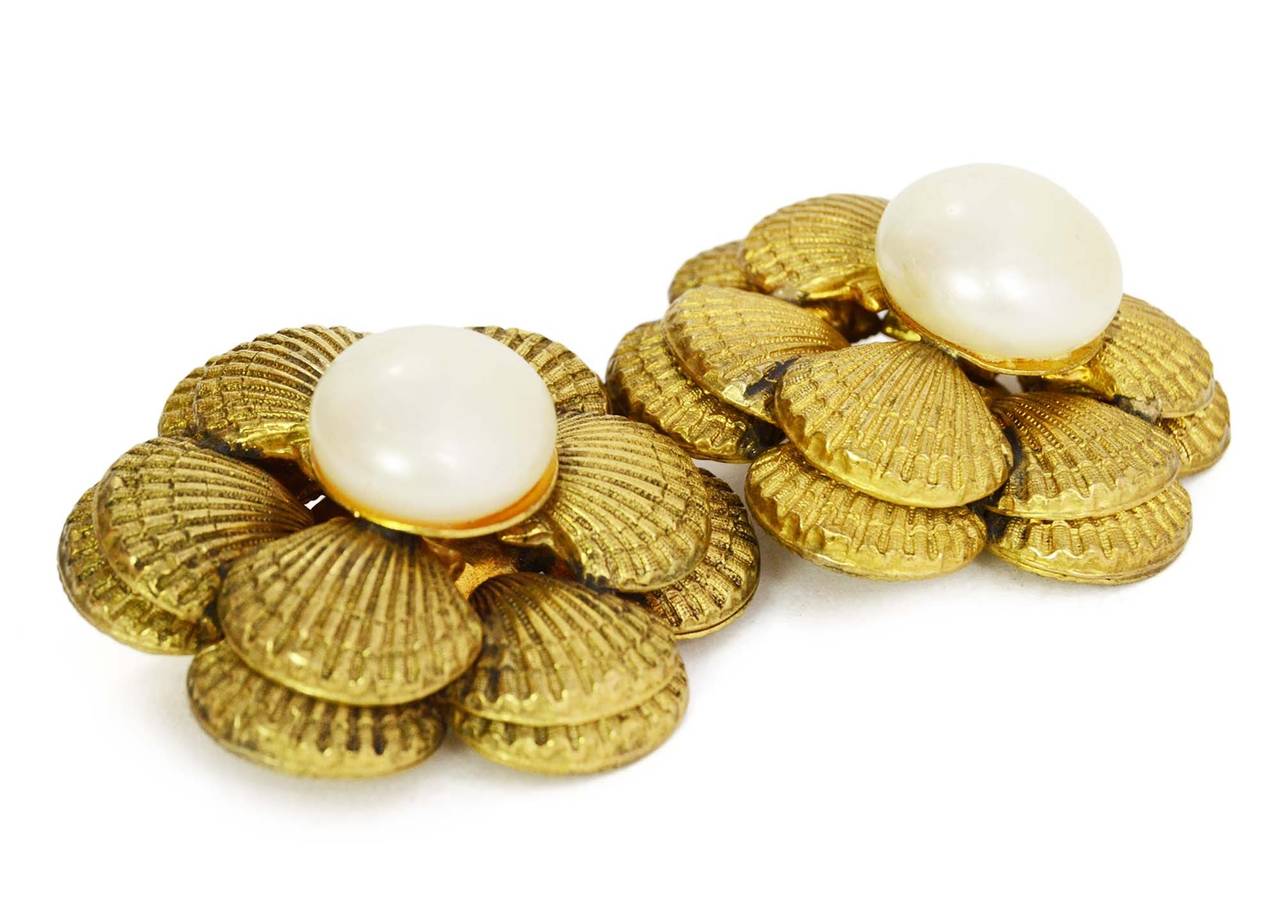 Chanel Vintage Gold Sea Shell & Pearl Flower Clip On Earrings
Features goldtone sea shells surrounding pearl to make look like flower 
Made in: France
Stamp: Chanel CC Made in France
Closure: Clip on closure
Color: Goldtone and