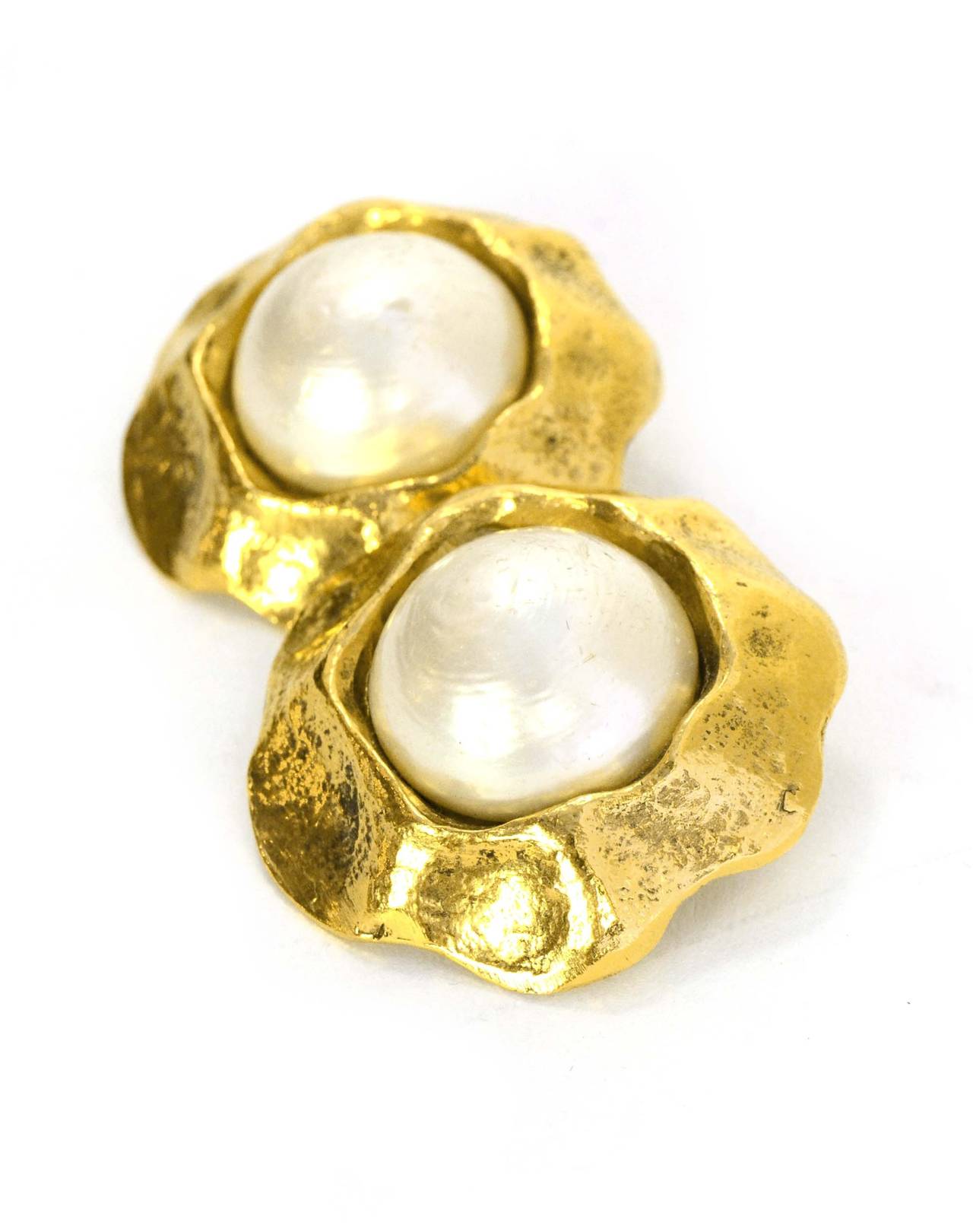 Chanel Vintage '50s-'60s Hammered Gold & Pearl Clip On Earrings
Made in: France
Year of Production: 1950s-1960s
Stamp: CHANEL
Closure: Clip on
Color: Goldtone and ivory
Materials: Metal and faux pearl
Overall Condition: Excellent with the