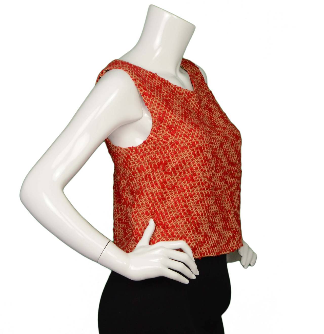 Chanel Vintage '99 Red & Tan Tweed Shell Top 
Made in: France
Year of Production: 1999
Color: Red and tan
Composition: 95% polyester, 5% acrylic
Lining: Multi-colored dot print, 100% silk
Closure/opening: Pull on
Exterior Pockets: