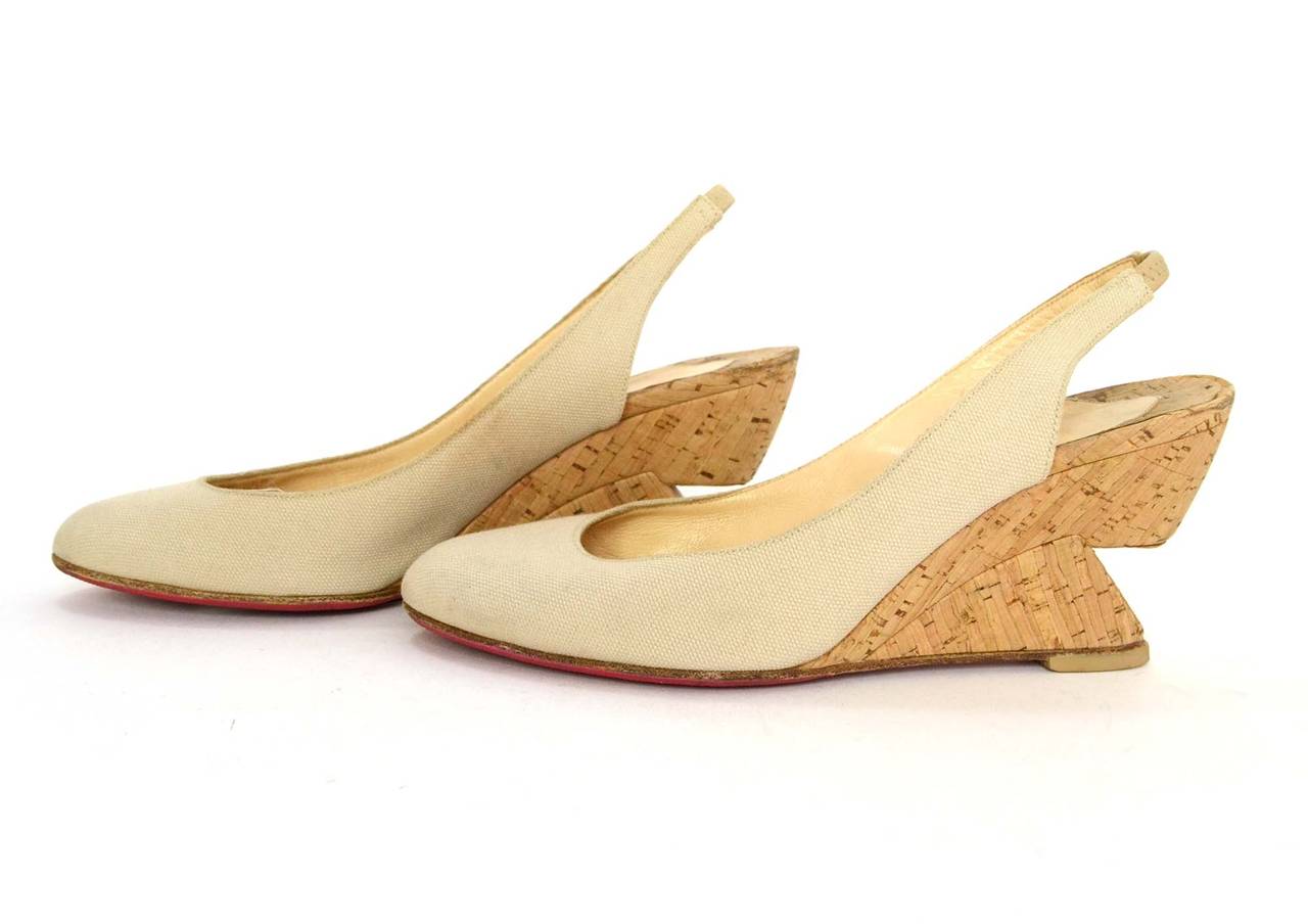 Christian Louboutin Nude Canvas Slingback Cut-Out Wedges
Features cork cut-out wedge heel
Made in: Italy
Color: Nude
Composition: Canvas and cork
Sole Stamp: Christian Louboutin Made in Italy 36
Closure/opening: Slide on with elastic