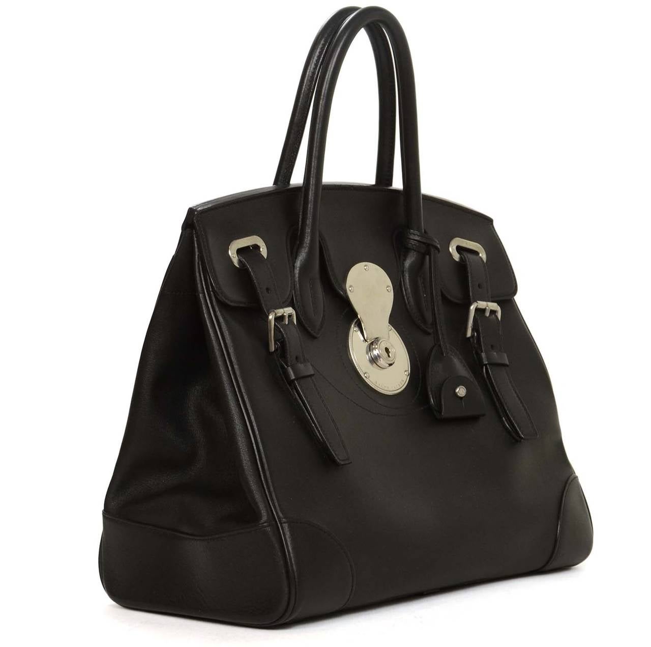 Ralph Lauren Black Ricky Bag
Made in: Italy
Color: Black
Hardware: Silvertone 
Materials: Leather, metal
Lining: Red leather
Closure/opening: Flap with posh lock and adjustable straps
Exterior Pockets: None
Interior Pockets: One zipper and