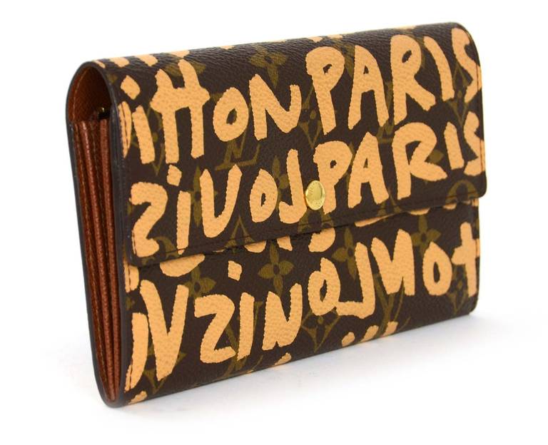 Made in France circa 2001
Date stamp reads “TH0041”
Interior stamped “LOUIS VUITTON” “PARIS” “made in France” 
Features monogram LV logo with limited edition Steven Sprouse LOUIS VUITTON graffiti written on top in peach
Wallet has two
