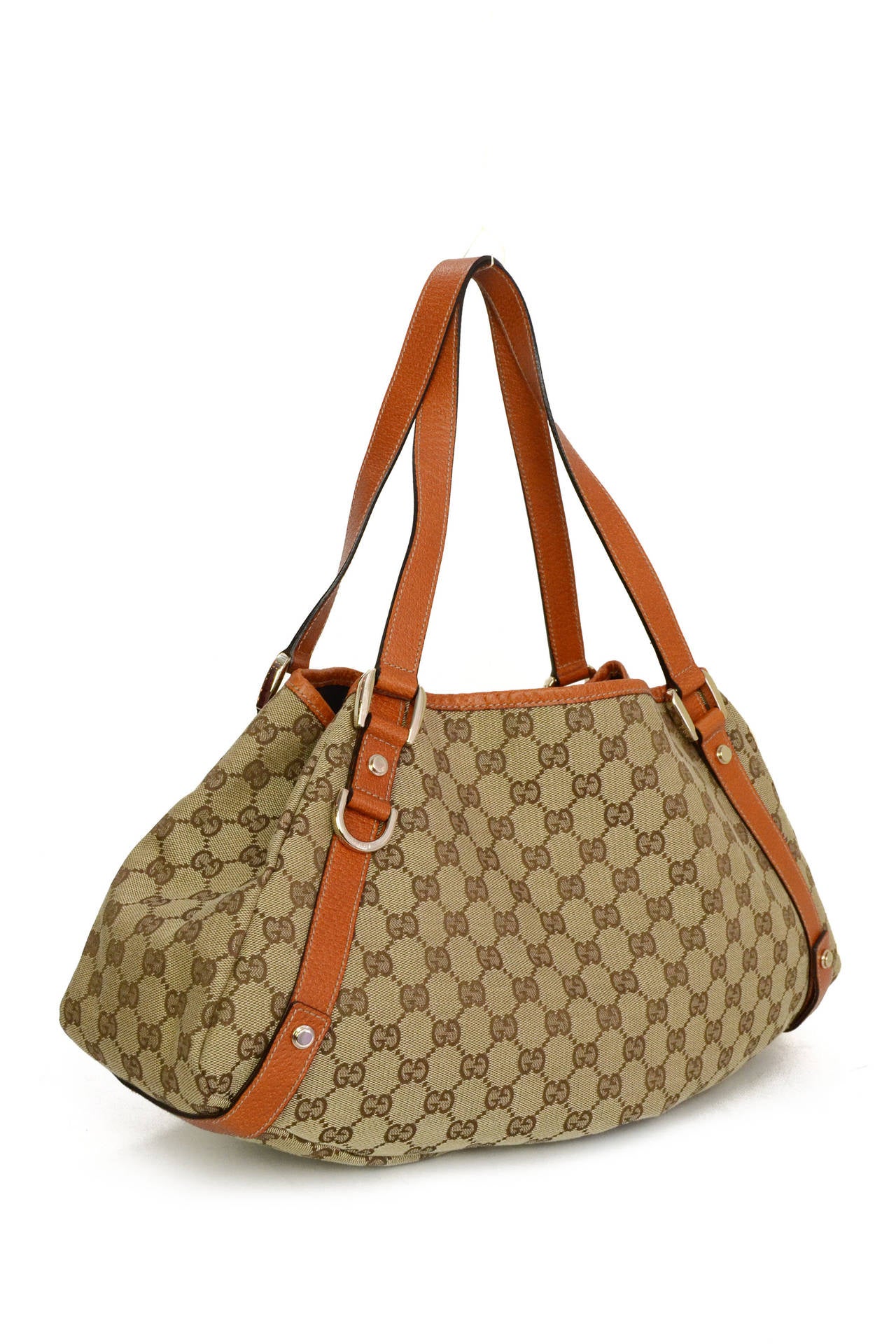 Gucci Monogram Canvas & Orange Leather Tote Bag
Features orange leather trim throughout
Made in: Italy
Color: Tan, orange and goldtone
Hardware: Goldtone
Materials: Leather and canvas
Lining: Brown textile
Closure/opening: Open top with side