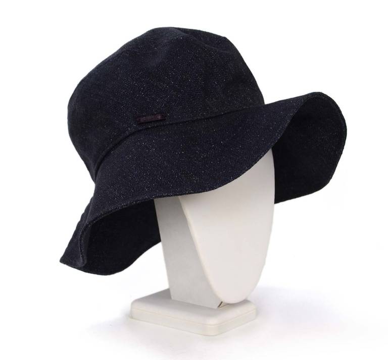 Dark navy denim
Black grosgrain lining in the interior
Iridescent CHANEL plaque on the front of hat
Marked size 57