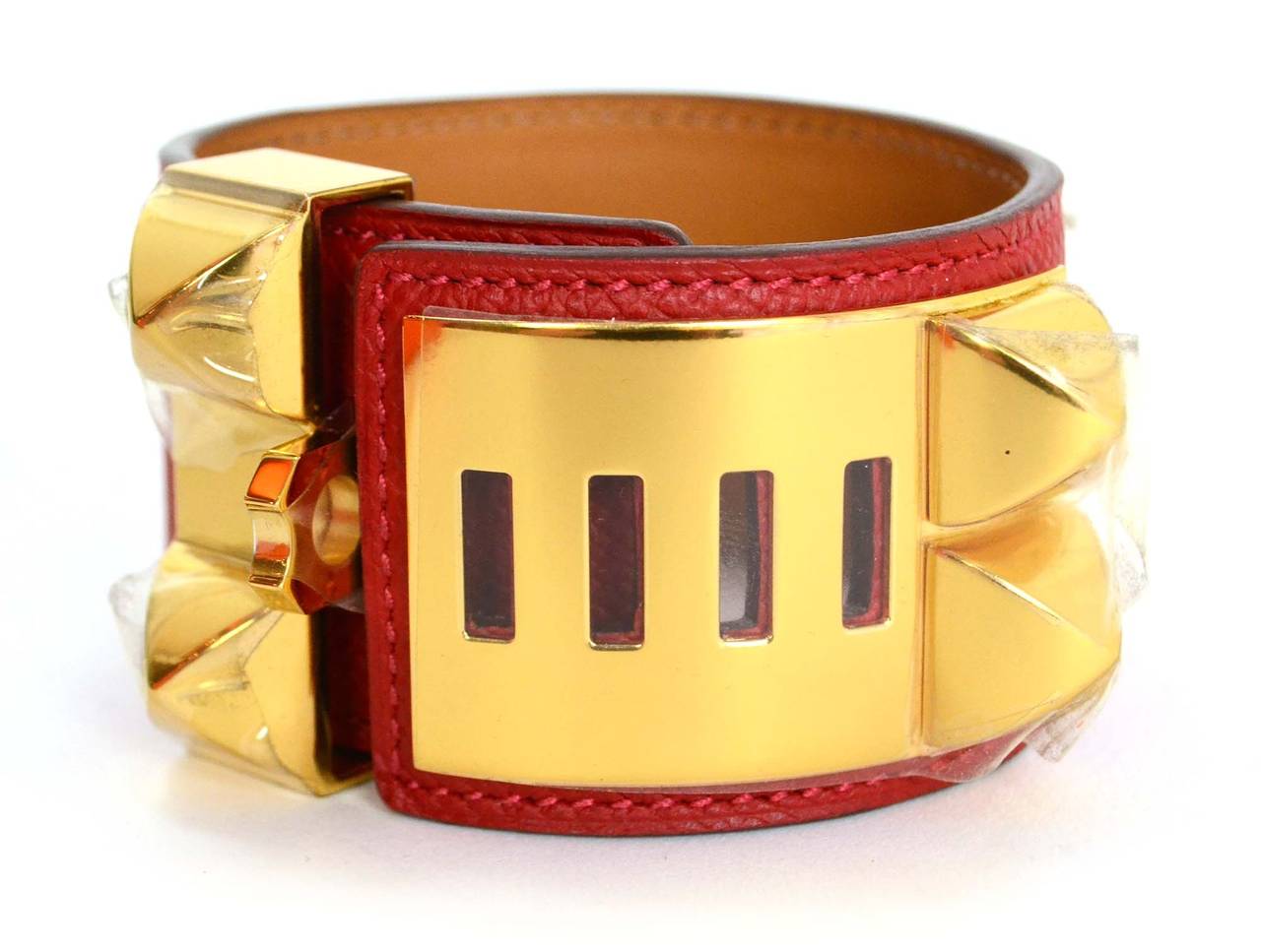 Hermes Rouge Casaque Red Epsom CDC Cuff
    Made in: France
    Year of Production: 2013
    Color: Red and goldtone
    Materials: Epsom leather and metal
    Closure/Opening: Four slots to accommodate different wrist sizes; size locks into