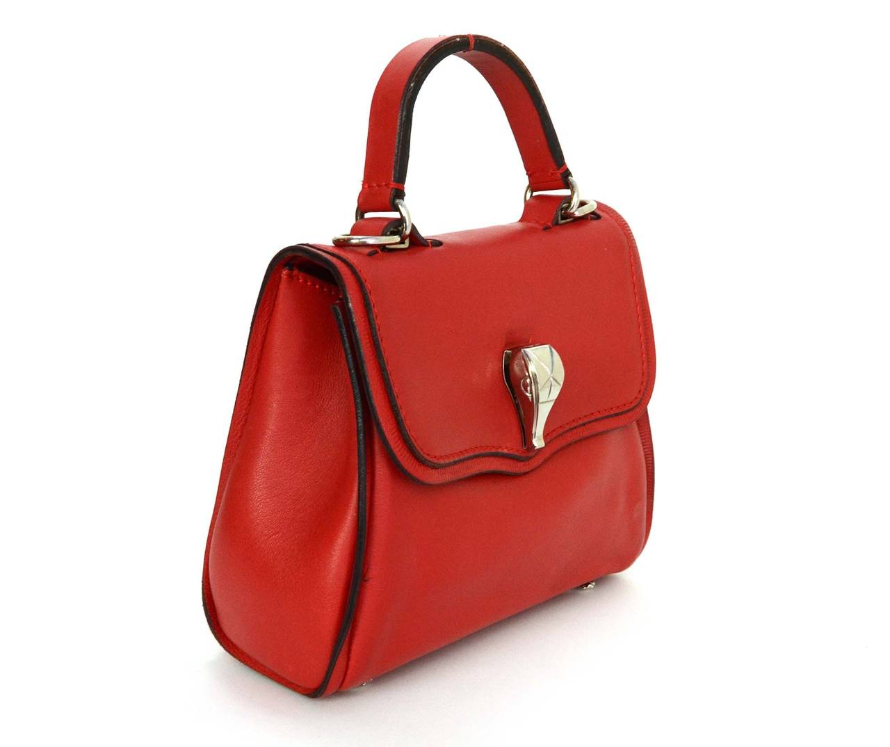 Kieselstein-Cord Red Leather Small Satchel
Features small silvertone alligator accent on front of bag
Made in: Italy
Color: Red and silvertone
Hardware: Silvertone
Materials: Leather and metal
Lining: Red leather
Closure/opening: Flap top