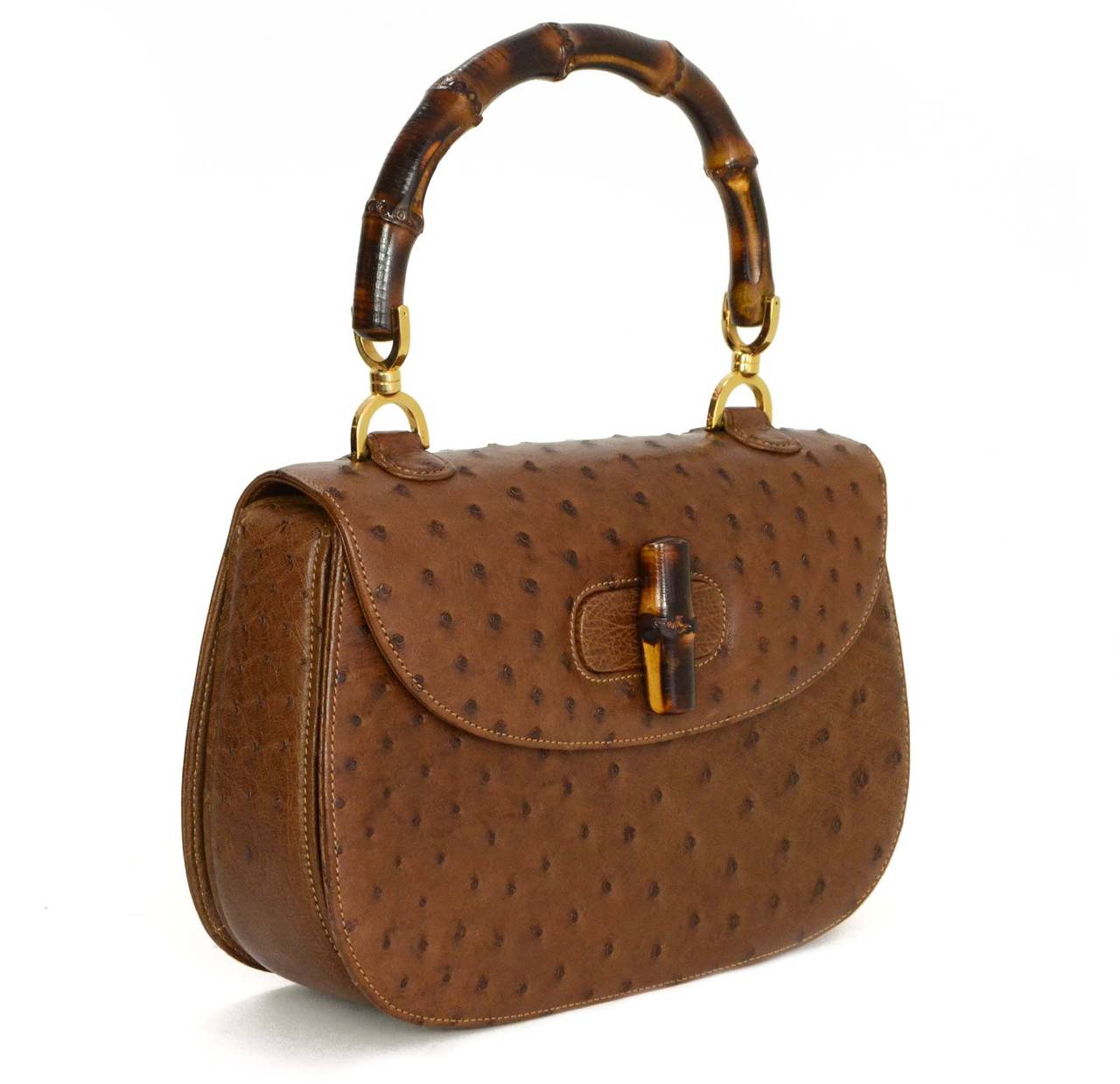 Gucci Vintage '70s-'80s Brown Ostrich Vintage Evening Bag
Features bamboo handles and twist lock
    Made in: Italy
    Color: Brown and goldtone
    Hardware: Goldtone
    Materials: Leather, suede, wood, and metal
    Lining: Brown suede
  