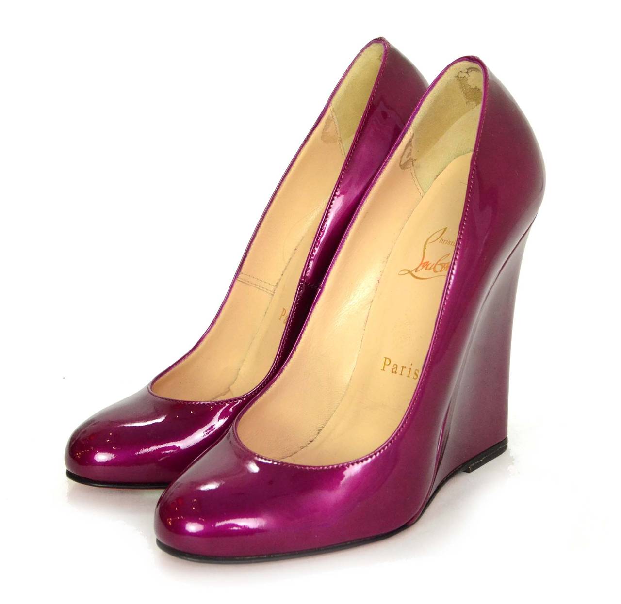 Christian Louboutin Iridescent Magenta Patent Wedges
Made in: Italy
Color: Magenta
Composition: Patent leather
Sole Stamp: Christian Louboutin Made in Italy 36 1/2
Closure/opening: Slide on
Current Retail: $660 + tax
Overall Condition: