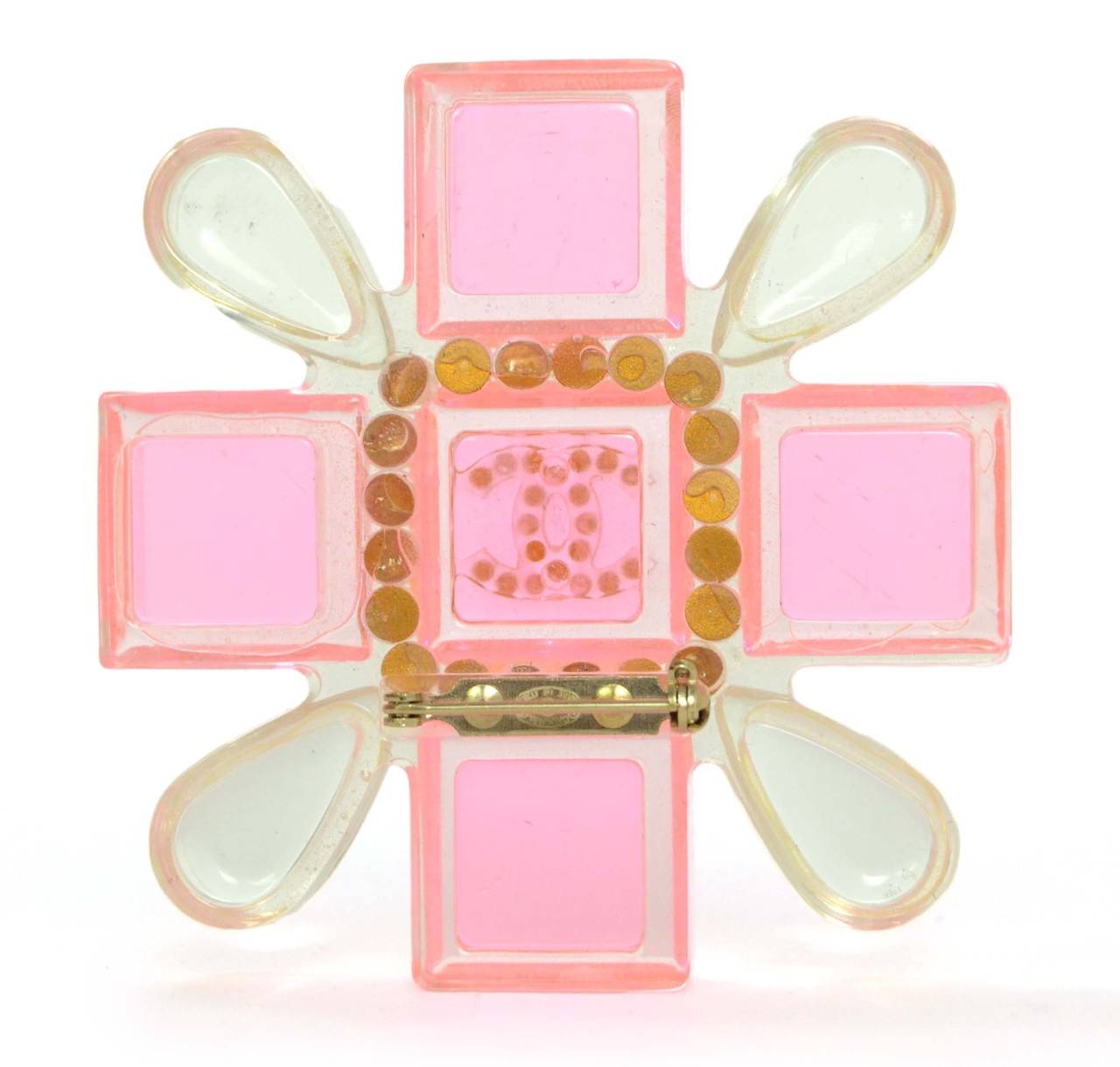 Chanel Pink & Clear Resin Cross Brooch
Features clear resin beads framing rhinestone CC center
Made in: Italy
Year of Production: 2004
Stamp: 04 CC A
Closure: Pin back closure
Color: Pink and clear
Materials: Resin, rhinestones and metal
Overall