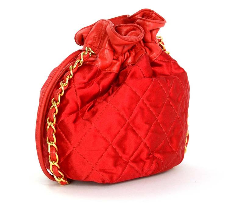 Chanel Red Satin Quilted Drawstring Bag W/Leather Trim

    Age: c. 1986-1988
    Made in Italy
    Materials: satin, leather
    Features interior zippered pocket, top leather trim with drawstring closure
    Date stamp: 0557649
    Stamped: