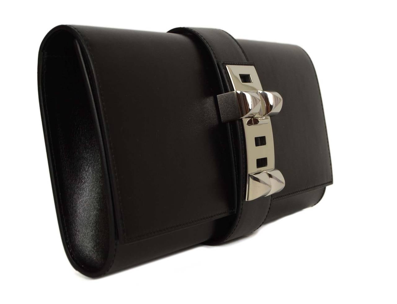 Hermes Black Box Leather 29cm Medor Clutch 
Made in: France
Year of Production: 2008
Color: Black and silvertone
Hardware: Palladium
Materials: Box leather and metal
Lining: Black chevre leather
Closure/opening: Flap top with palladium