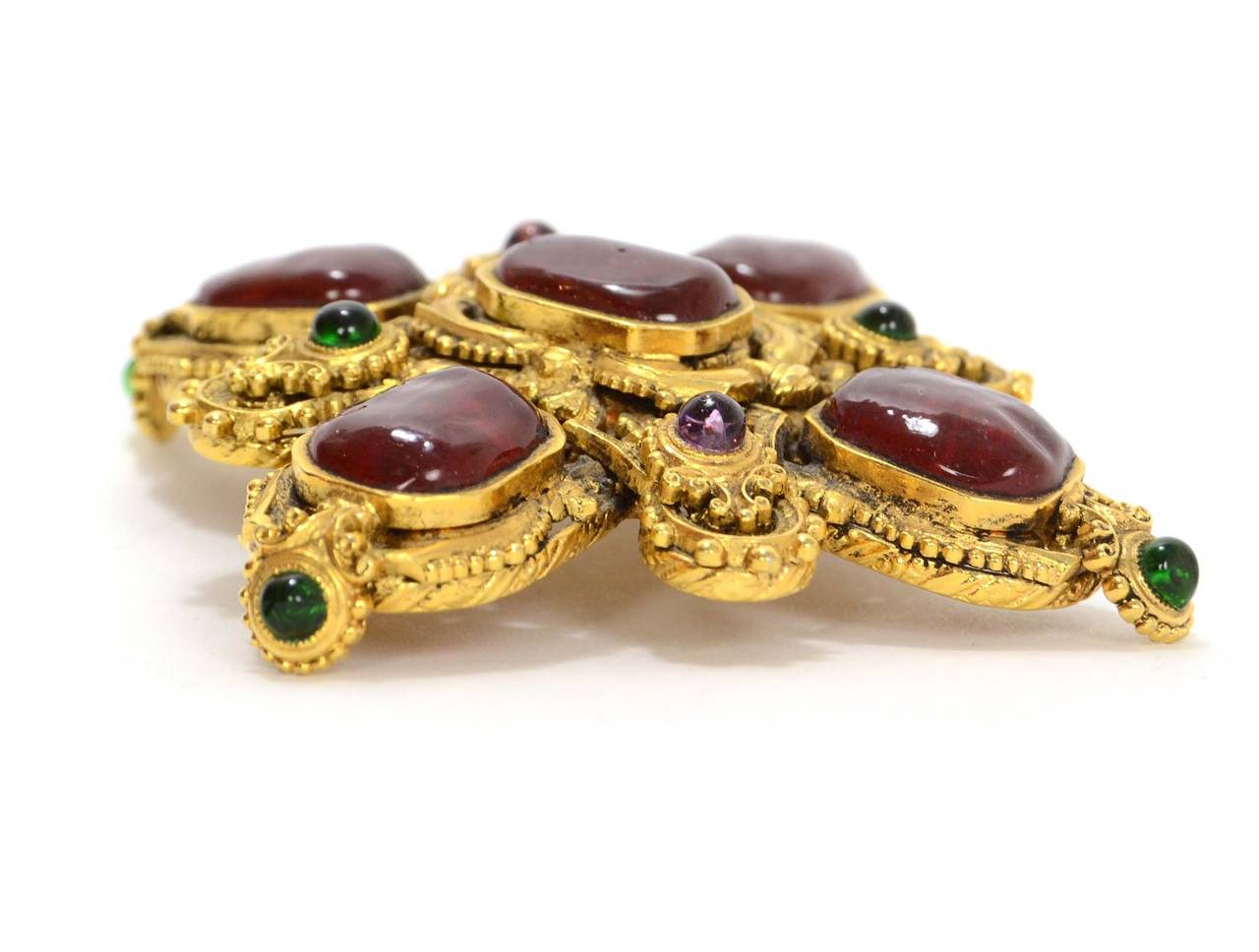 Chanel Vintage '70s-'80s Gold & Gripoix Brooch
Features burgundy, green and pruple gripoix throughout intricate goldtone design.  Hook at back allows brooch to also be worn as a pendant on a necklace

Made in: France
Year of Production: