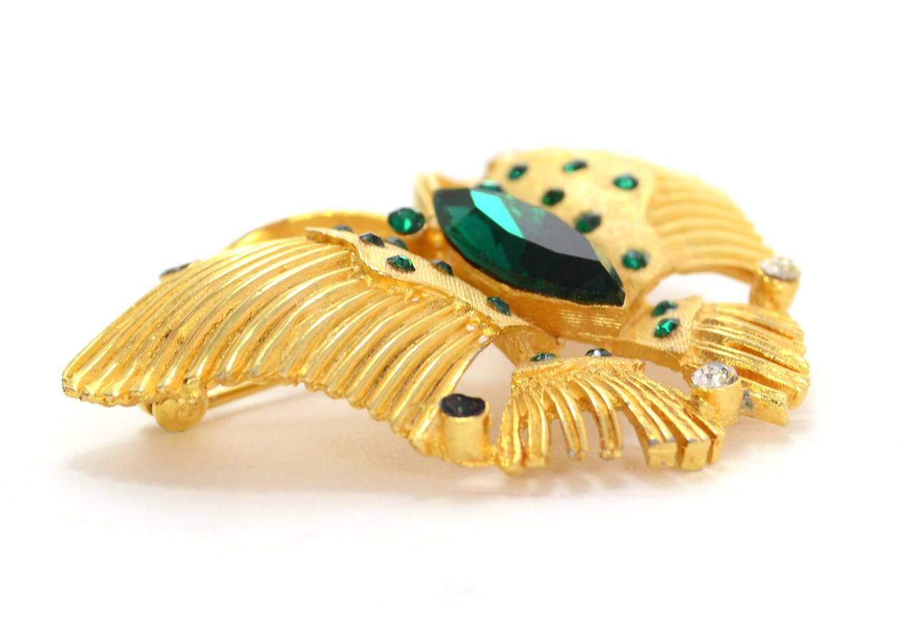Kramer Gold & Emerald Butterfly Brooch
Features emerald green and clear rhinestone details
Stamp: Kramer
Closure: Pin back closure
Color: Goldtone and emerald green
Materials: Metal and rhinestones
Overall Condition: Very good pre-owned