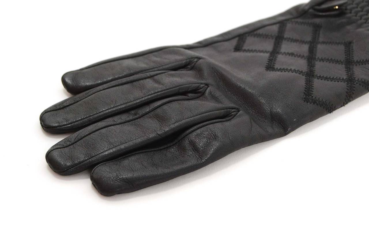 Chanel Black Leather 3/4 Sleeve Gloves
Features quilted detailing at top and small silvertone CC's at wrist
Made In: France
Color: Black
Composition: 100% leather
Overall Condition: Excellent preowned condition
Marked Size: 7.5
Length: 14.5