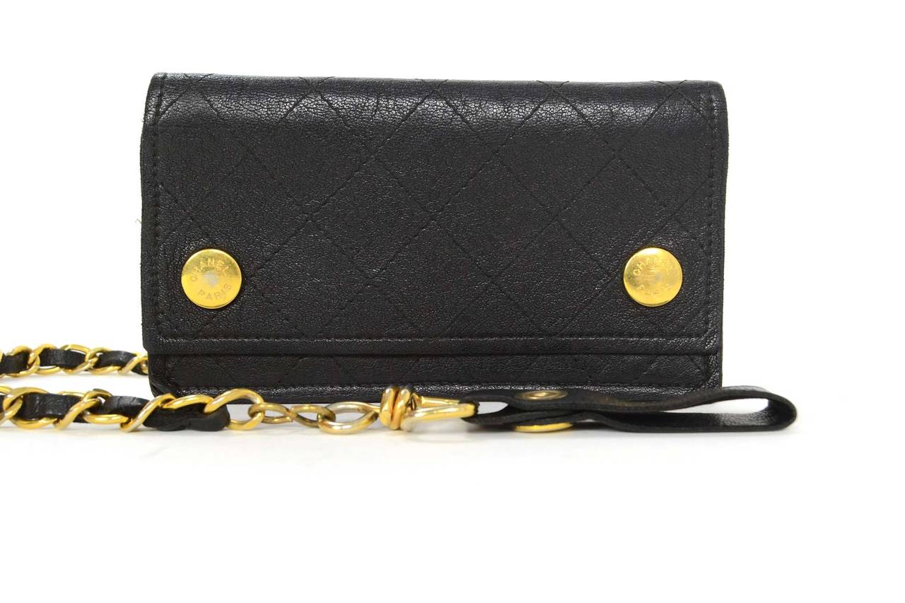 Chanel Vintage '92 Black Quilted Leather Wallet & Chain
Features leather snap at end of chain strap 
Made in: France
Year of Production: 1992
Color: Black and goldtone
Hardware: Goldtone
Materials: Leather and metal
Lining: Black