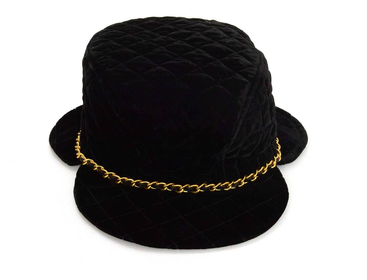 Chanel Black Quilted Velvet Trapper Hat
Features leather woven goldtone chain detailing around top
Color: Black and goldtone
Composition: Velvet
Lining: Black textile
Overall Condition: Excellent vintage, pre-owned condition with the exception