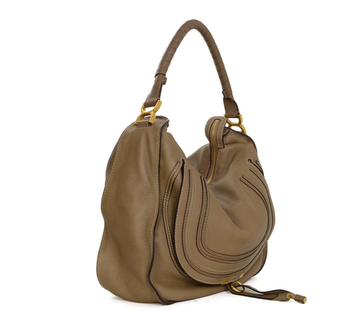Chloe Taupe Leather Marcie Shoulder Bag 
Made in: Italy
Color: Taupe and goldtone
Hardware: Goldtone
Materials: Leather
Lining: Brown canvas
Closure/opening: Zip across top
Exterior Pockets: Front slit pocket under flap top
Interior Pockets: