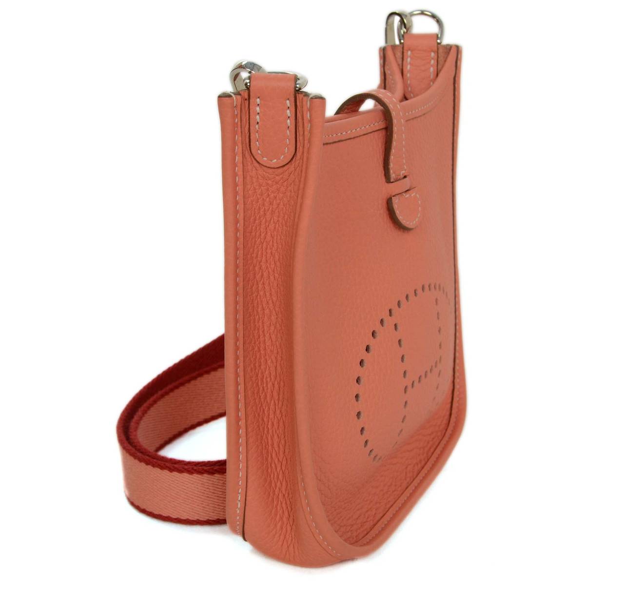 Hermes Peach Crevette Clemence Leather Evelyne TPM Bag
Features detachable canvas crossbody strap
Made in: France
Year of Production: 2013
Color: Crevette (peachy color)
Hardware: Palladium
Materials: Clemence leather and palladium