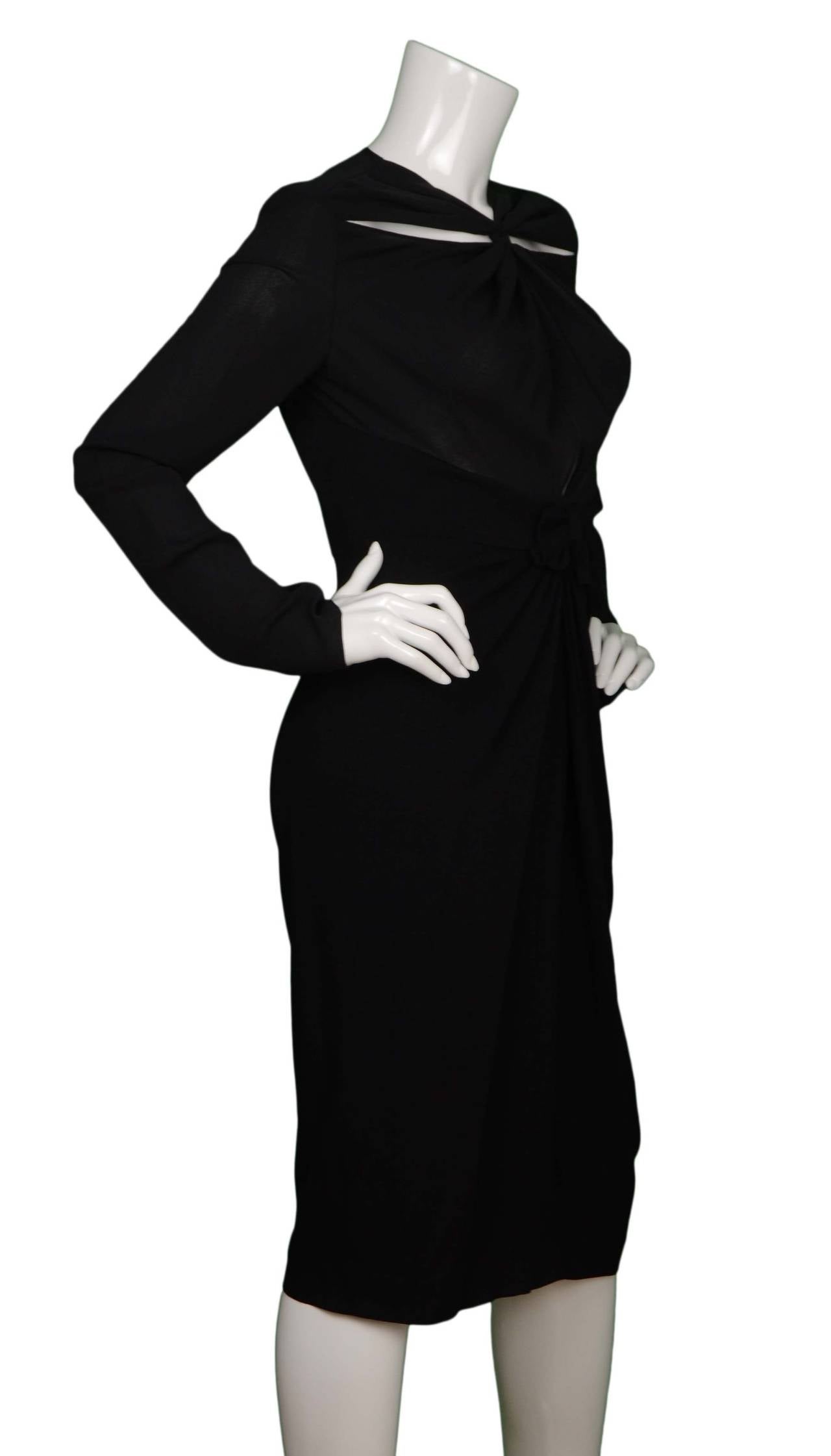 Proenza Schouler Black Crepe Long Sleeve Cocktail Dress
Features two cut outs at neckline and bow at front center waistline 
Made in: China
Color: Black
Composition: 100% viscose with silk trim
Closure/opening: Center back zip up
Exterior