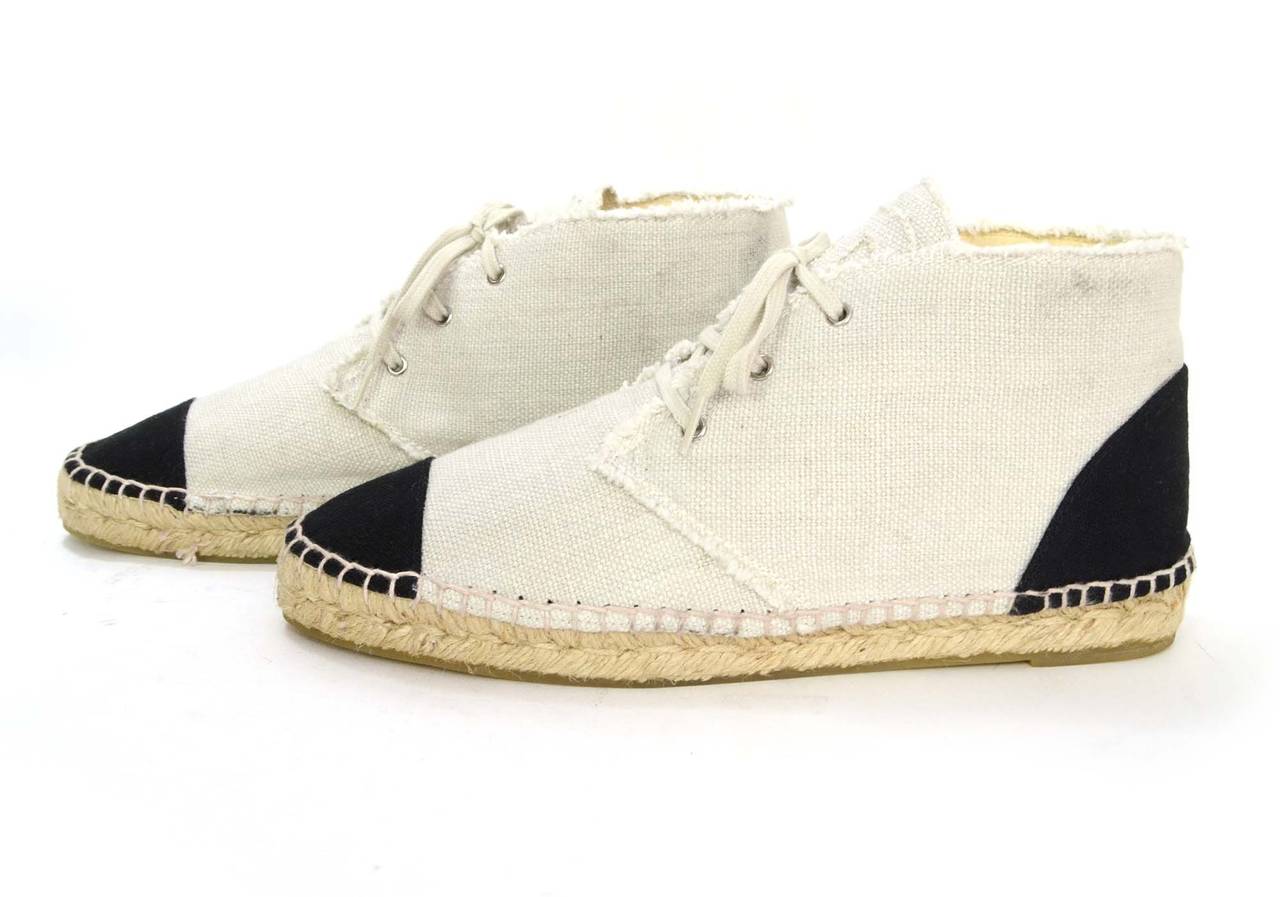 Chanel Beige & Navy Canvas Espadrille High-Top Sneakers
Features CC on tongues
Made in: Spain
Color: Beige
Composition: Canvas
Sole Stamp: 40 Made in Spain Chanel CC
Closure/opening: Laces
Overall Condition: Excellent pre-owned condition with