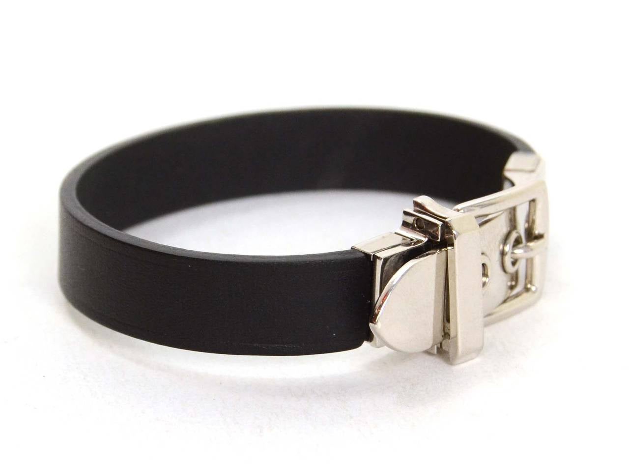Hermes Black Leather & Palladium Buckle Bracelet
Made In: France
Year of Production: 2014
Color: Black and silvertone
Materials: Leather and palladium hardware
Stamp: R stamp in square
Closure: Buckle notch and palladium side lever that opens