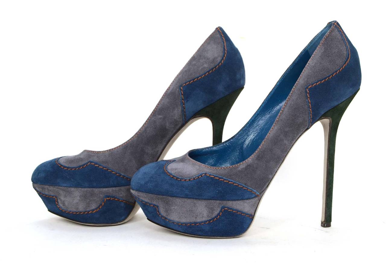Sergio Rossi Blue & Grey Suede Platform Pumps
Features orange contrast stitching throughout and dark green suede covered heels
Made In: Italy
Color: Blue, grey, green and orange
Materials: Suede
Closure/Opening: Slide on
Sole Stamp: Vero Cuoio