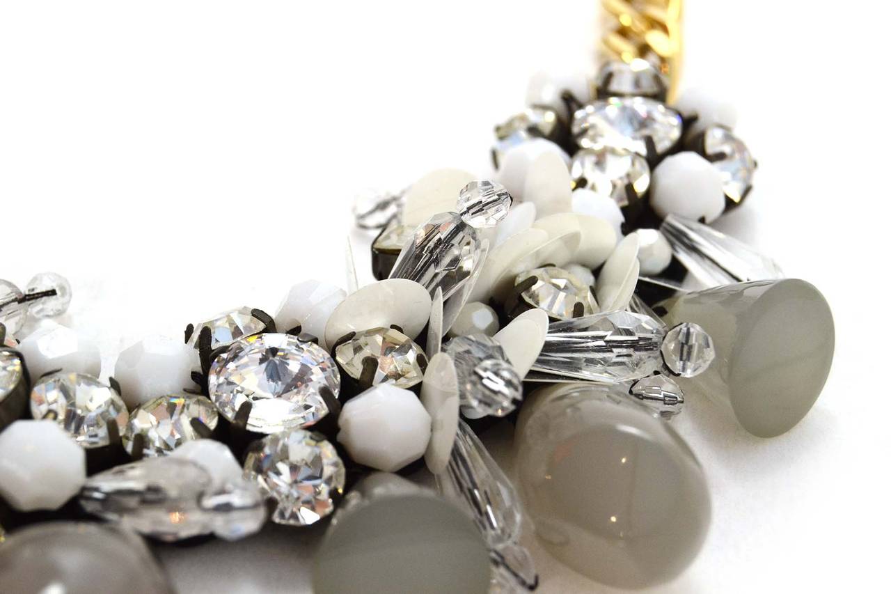 Marni White & Grey Beaded Chain & Tie Necklace
Features multiple shapes and sizes of clear, grey and white beading
Color: Black, goldtone, grey, white and clear
Materials: Satin, metal, sequins, rhinestones and resin beads
Closure: Satin