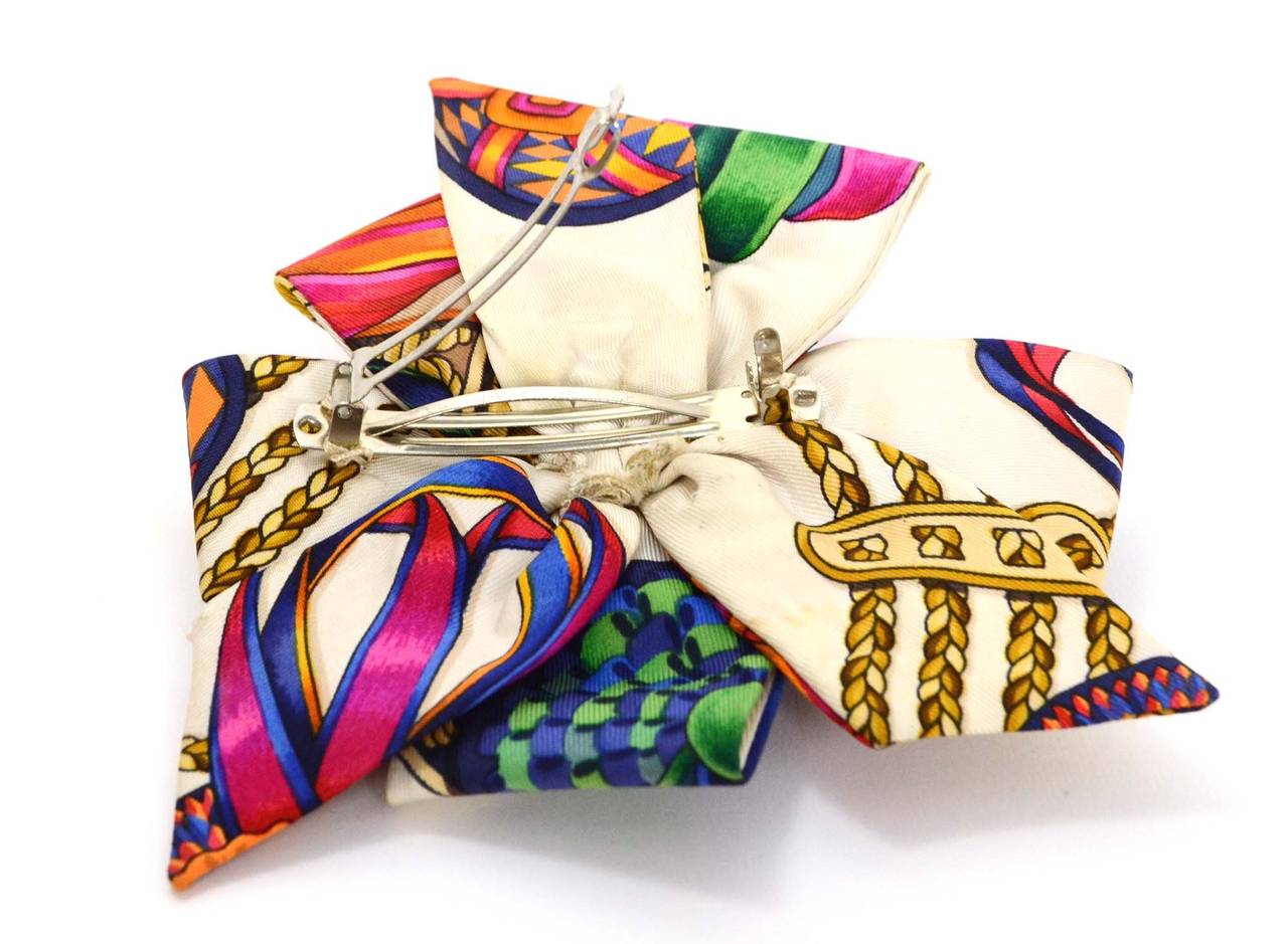 Hermes Multi-Colored Silk Hair Barrette
Features bows and ribbons printed throughout
Made In: France
Color: Ivory, red, orange, yellow, blue, green and black
Materials: Silk
Stamp: Made in France
Closure: Push hinge closure
Overall Condition: