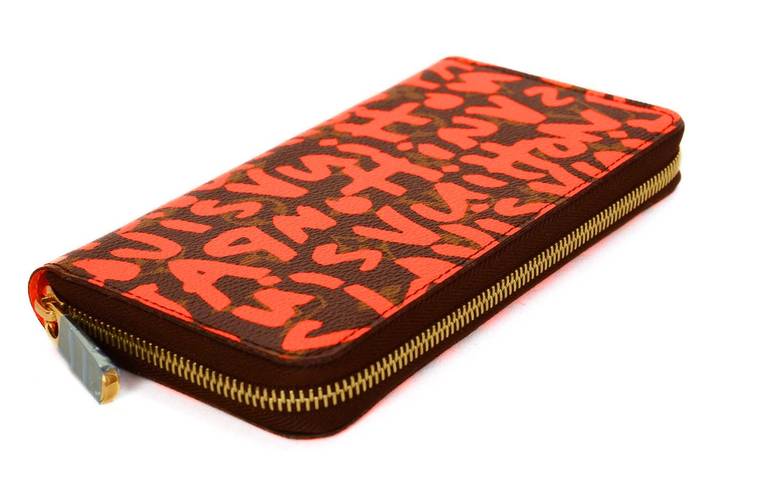 c.2008
Designed by Stephen Sprouse for Louis Vuitton
Monogram zippy wallet covered in neon orange graffiti
Neon orange leather lining
Eight credit card slots
Center zip compartment for coins
Five sections for bills and bank notes
Zip around