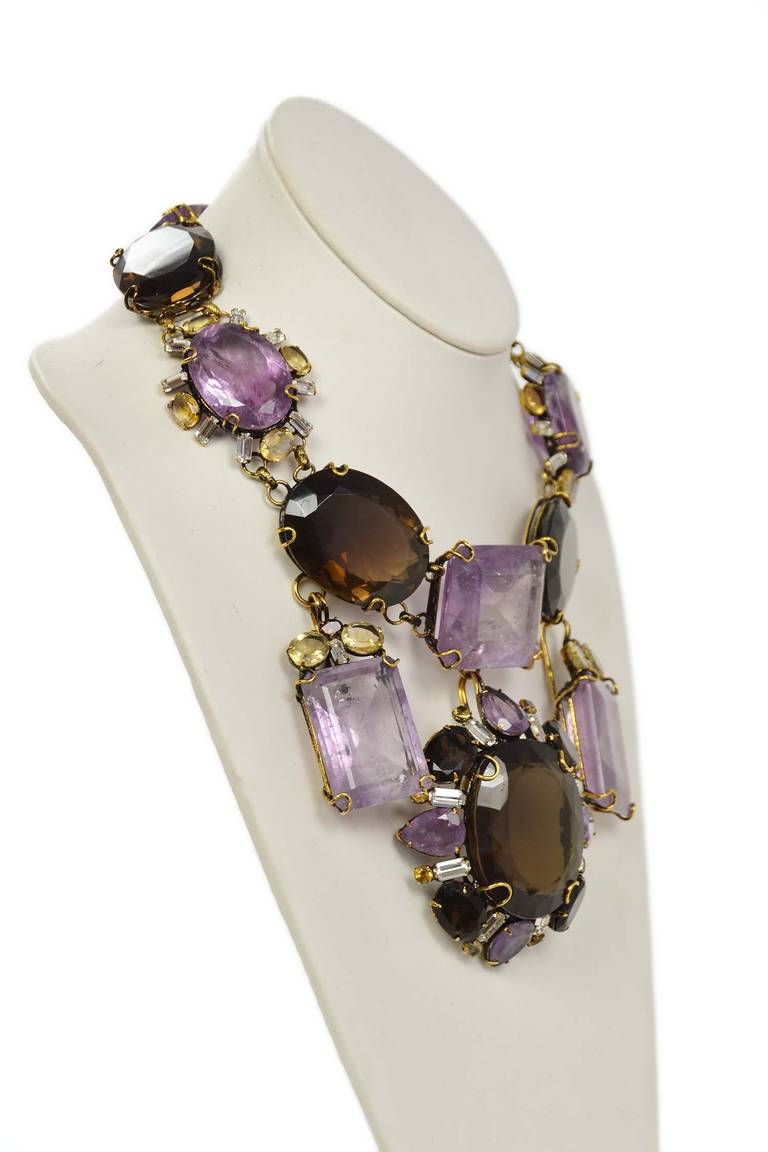 Iradj Moini large stone choker with goldtone metal detail
Comes with three detachable pendants: one large circle, and two smaller rectangle with surrounding stones.
Choker alternates amethyst and topaz color stones
Stamped Iradj Moini

Total