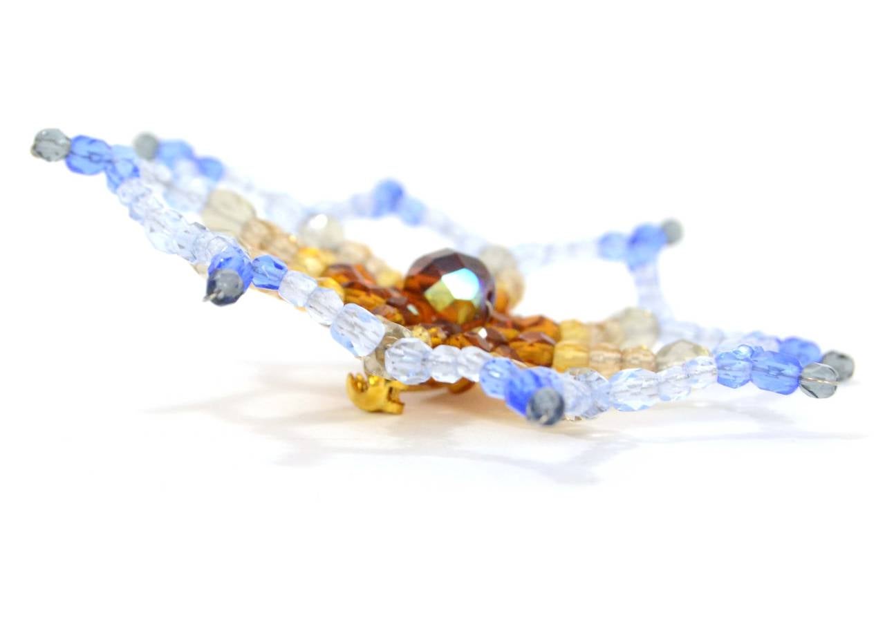 Chanel Vintage '98 Blue & Amber Beaded Flower Pin
Features gradient colors from blue to pale blue to yellow and amber

Made In: France
Year of Production: 1998
Color: Green, blue, yellow and amber
Materials: Glass beads
Closure: Pin back