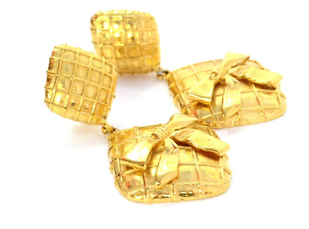 Chanel Vintage '70s Gold Double Diamond & Bow Clip On Earrings 
Features quilting throughout both diamond shapes

Made In: France
Year of Production: 1970's
Color: Goldtone
Materials: Metal
Closure: Clip on 
Stamp: Chanel CC Made in