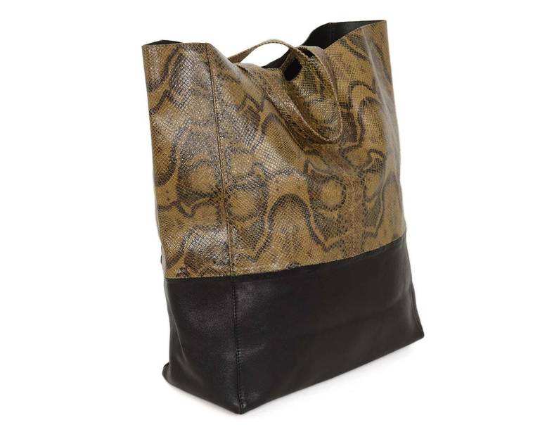 Celine Brown Python/Black Leather Bicabas Tote

    Made in Italy
    Made of black leather and brown python with black leather lining
    Interior features one zippered pocket
    Serial number reads U-GA-0130
    Exterior of bag stamped