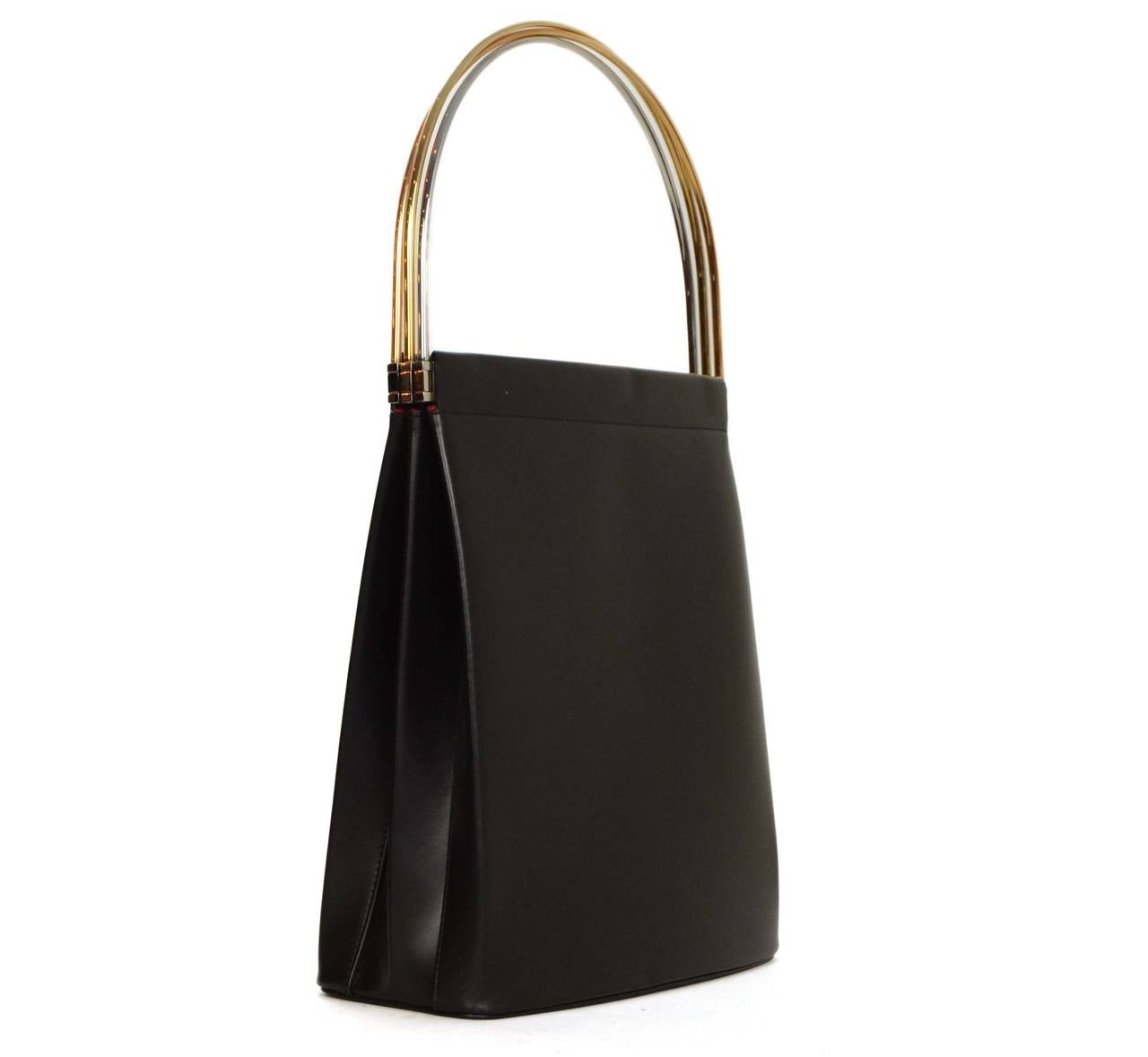 Cartier Black Leather Trinity Handle Bag
Features Goldtone, rose goldtone, and silvertone intertwining bars that create top handle
Made In: France
Color: Black, goldtone and silvertone
Hardware: Goldtone, rose goldtone, and