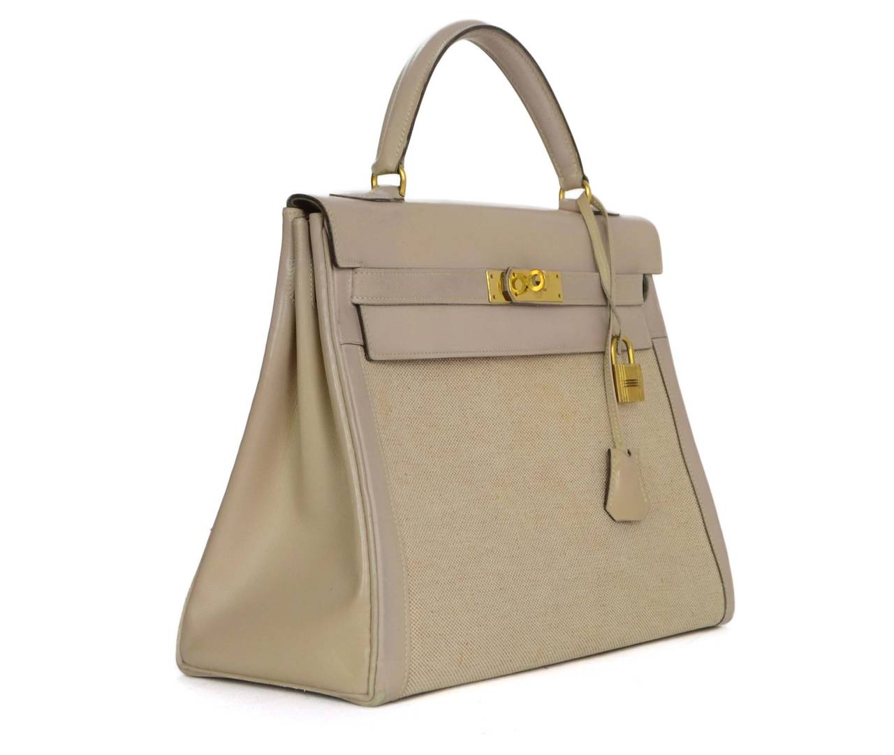 Hermes Vintage '56 Beige Toile 32cm Kelly Bag 
Features leather trim and flap top with toile canvas as the main panels of bag
Made In: France
Year of Production: 1956
Color: Beige
Hardware: Goldtone
Materials: Leather and toile canvas
Lining: