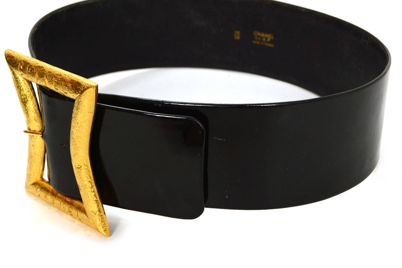 Chanel Vintage '93 Black Patent Wide Belt 
Features extra large goldtone buckle
Made In: France
Year of Production: 1993
Color: Black and goldtone
Materials: Metal and patent leather
Closure: Buckle and notch closure
Stamp: 93 CC P
Overall