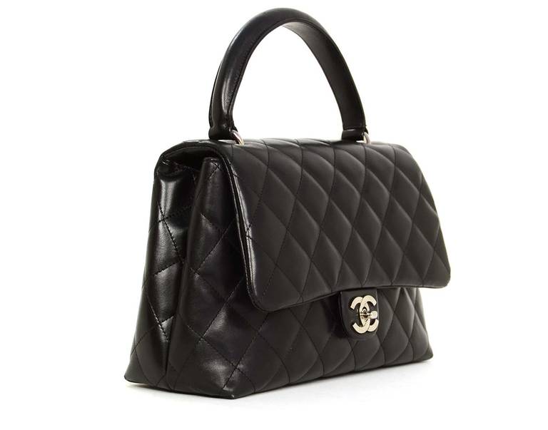 Chanel Black Quilted Leather Kelly Style Bag

Age: c. 2008-2009

Made in Italy 

Materials: lambskin leather, silvertone metal

Kelly style bag has a burgundy leather lining with a zippered pocket. Exterior features open pocket on the