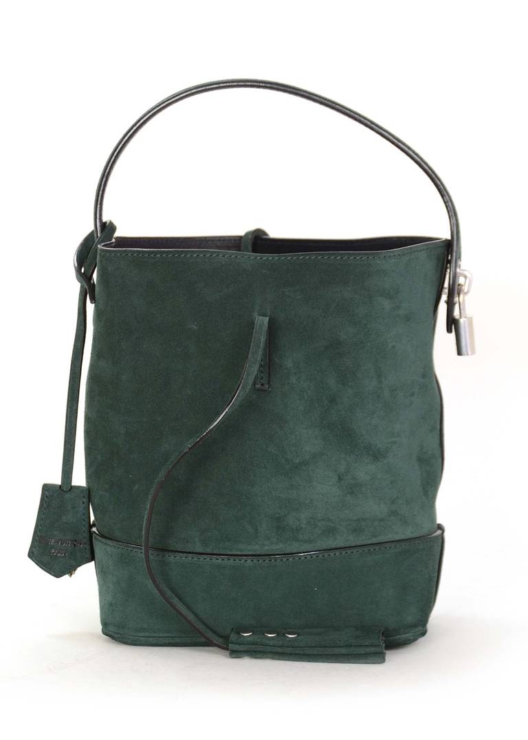 Louis Vuitton Limited Edition NN14 PM Bag

Designed by Marc Jacobs as an updated version of Louis Vuitton's classic Noe bag

Made of green suede with black leather lining and silvertone hardware

Features two string tie closure

Handle,