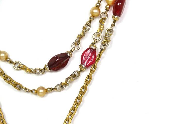 Chanel Vintage Extra Long Chain Necklace with Magnifying Pendant.

Features red and green gripoix stones and pearl detailing. Magnify pendant surrounded by rhinestones

    Made in: France
    Year of Production: 1983
    Materials: Goldtone