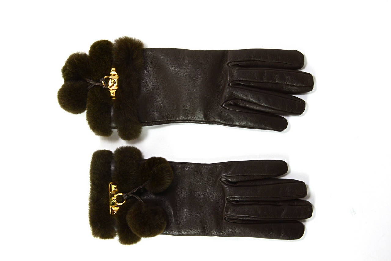 Features Hermes classic pyramid and door knocker medor design with two removable mink pompoms.

-Materials: Brown leather, brown mink, khaki cashmere lining
-Tag: HERMES PARIS MADE IN FRANCE
-Closure: Leather covered snap closure
-Hardware: