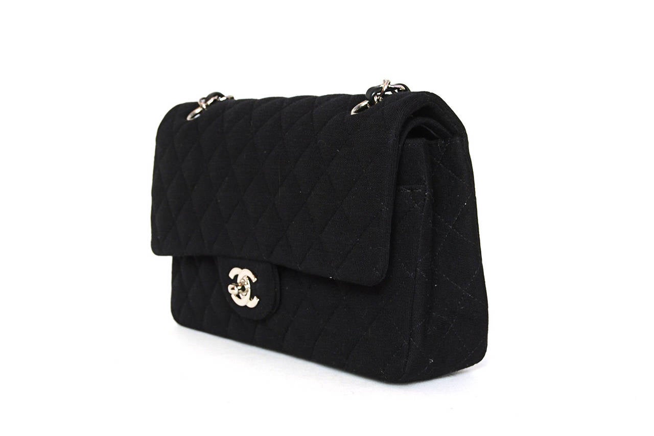CHANEL Black Jersey Quilted Double Flap Classic Bag

    Made in: France
    Year of Production: 2006
    Color: Black
    Materials: Jersey, leather.
    Hardware: Silvertone hardware
    Lining: Black leather lining
    Serial