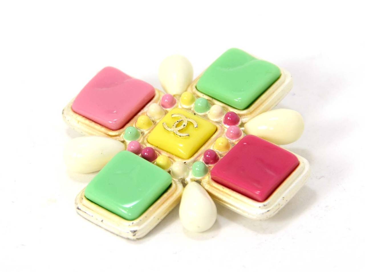This beautiful and versatile accessory can be worn as a brooch or hooked on a chain as a necklace pendant

Made in: France
Year of Production: 2004
Color: Pink, Green, White, Yellow
Materials: Enamel, resin & metal
Stamps: CHANEL 04 CC C MADE