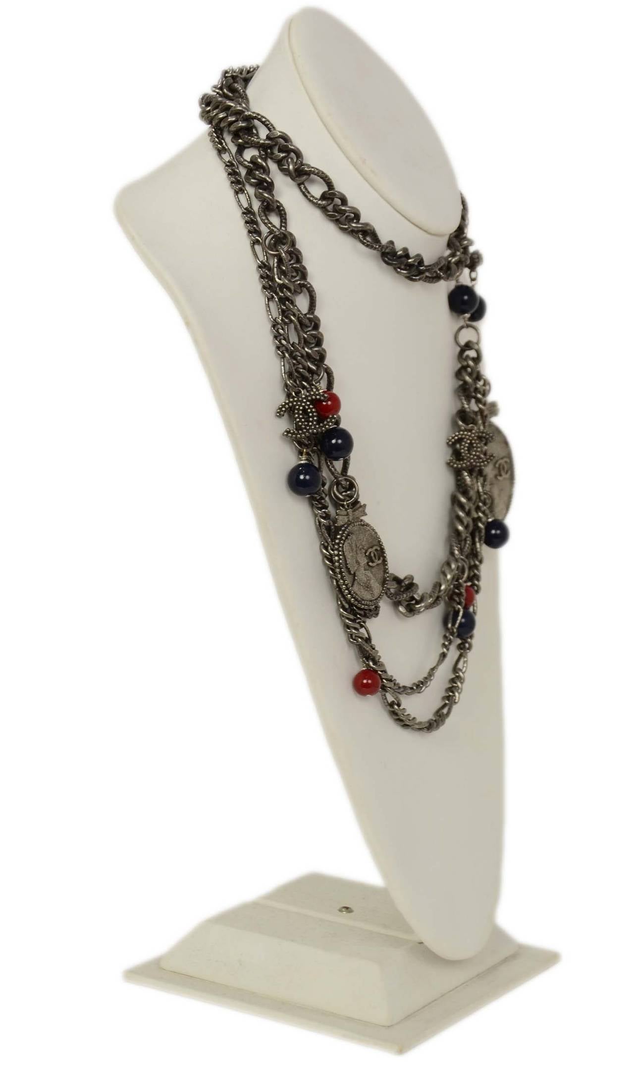 CHANEL Antiqued Silver Chain Link Belt W/ CC Cameo Charms and Red & Navy Beads
This versatile piece can be worn as a belt as well as a necklace as seen in the photos.

    Made in: France
    Year of Production: 2004
    Materials: Metal
   