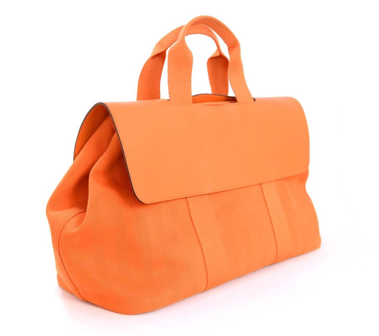 Hermes Orange Canvas Valparaiso GM Bag W/Leather Flap

    Age: c. 2011
    Made in France
    Materials: canvas, leather
    Roomy interior features a slip pocket. Snap button at sides to widen bag.
    Snap closure at center with leather