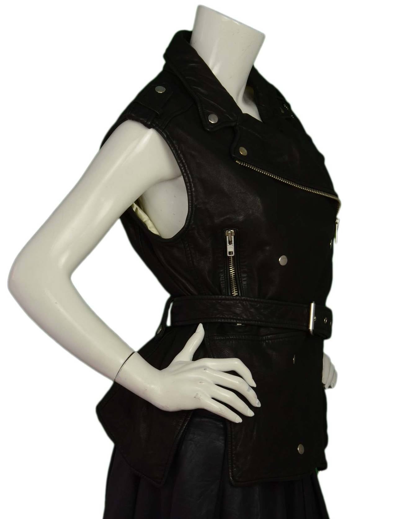 Features double breasted snap and zipper closure with side slits.

-Made in: India
-Color: Black with silver hardware
-Composition: 100% Distressed Lambskin
-Lining Composition: Quilted 100% Polyester
-Closure/opening: Zip/snap with adjustable