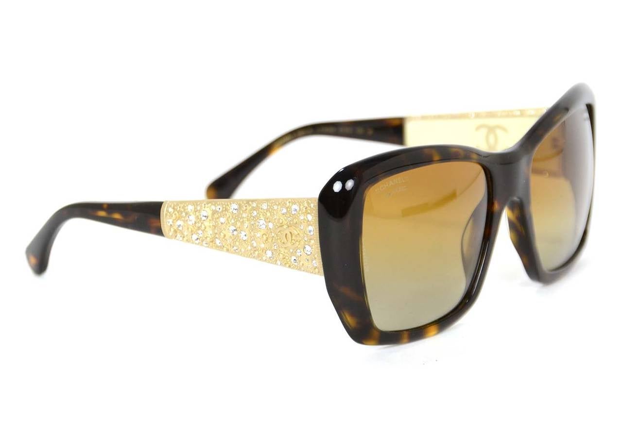 Chanel Bijoux Sunglasses
Features squared lens frames with brushed gold-tone rhinestone encrusted arms.

    Made in: Italy
    Year of Production: 2014
    Color: Brown tortoise
    Materials: Resin and strass crystals
    Hardware: Brushed