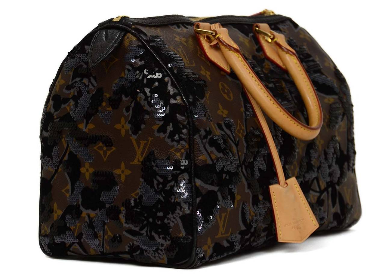 Louis Vuitton Fleur de Jais Sequin Speedy 30

-Made in: France
-Year of Production: 2010
-Color: Brown monogram, black, grey, tan
-Materials: Coated canvas, velvet, sequin, leather
-Hardware: Goldtone
-Lining: Tan textile
-Exterior Pockets: