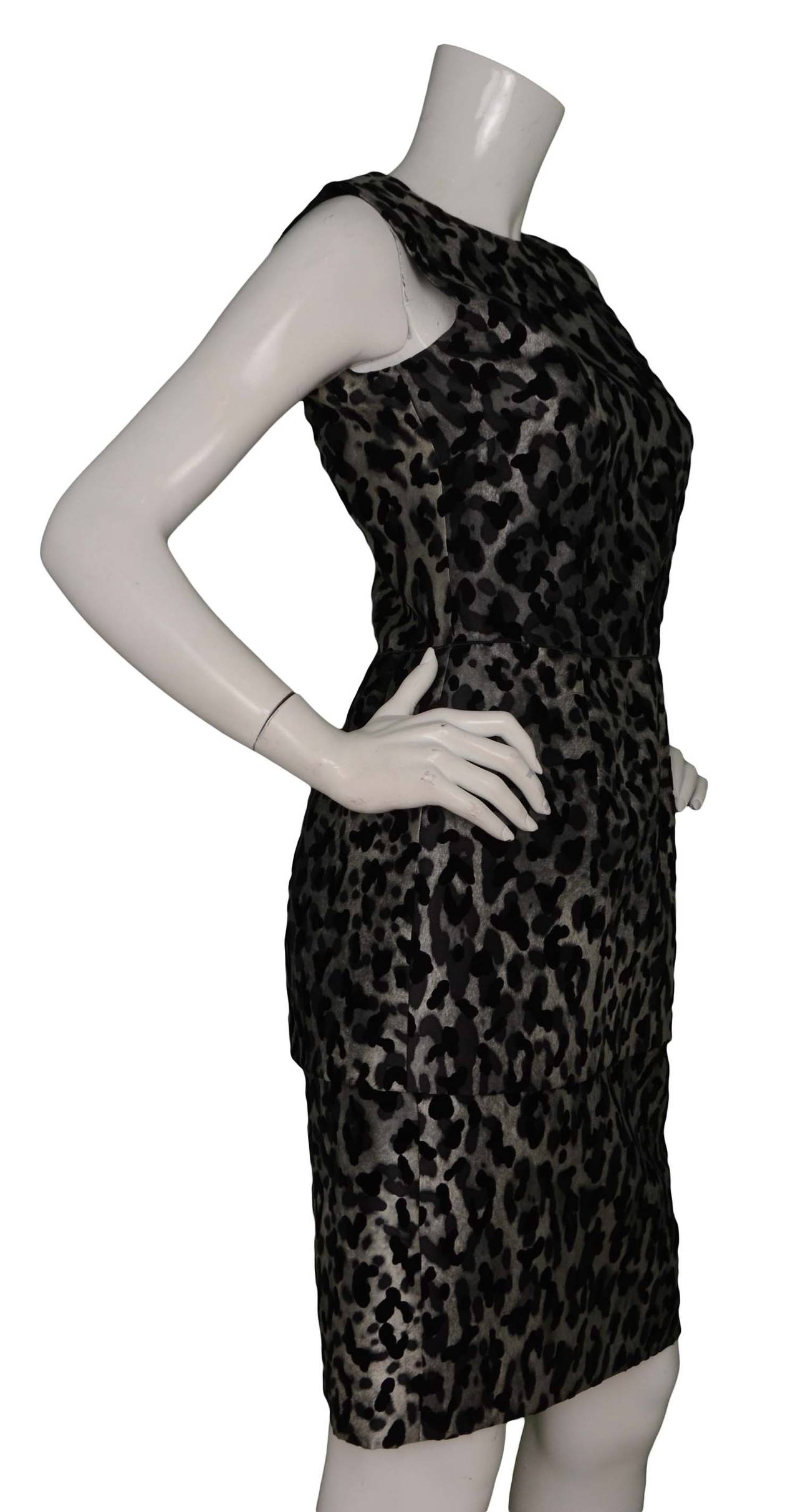 Features black velvet leopard spots and peplum skirt

-Made in: Italy
-Color: Grey and black
-Composition: 50% rayon, 50% silk
-Lining: 100% black silk
-Closure/opening: Silvertone back zipper
-Overall Condition: Excellent, with no visible