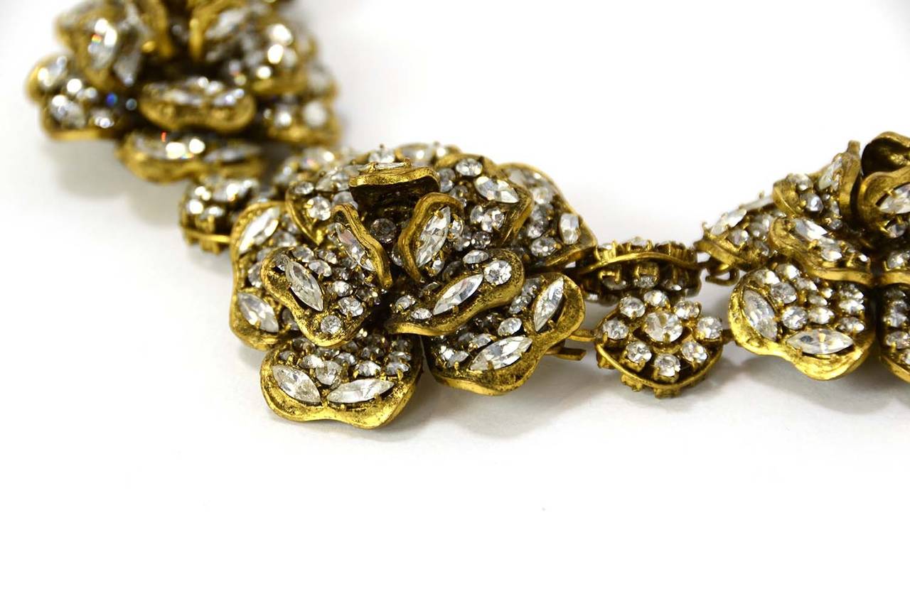 Chanel Vintage '70s Strass Crystal Camelia Necklace
Chanel vintage choker has five strass crystal graduating camellias

Made in: France
Year of Production: 1970-1980
Color: Crystal
Materials: Strass crystal and metal
Hardware: Goldtone
Closure: Hook